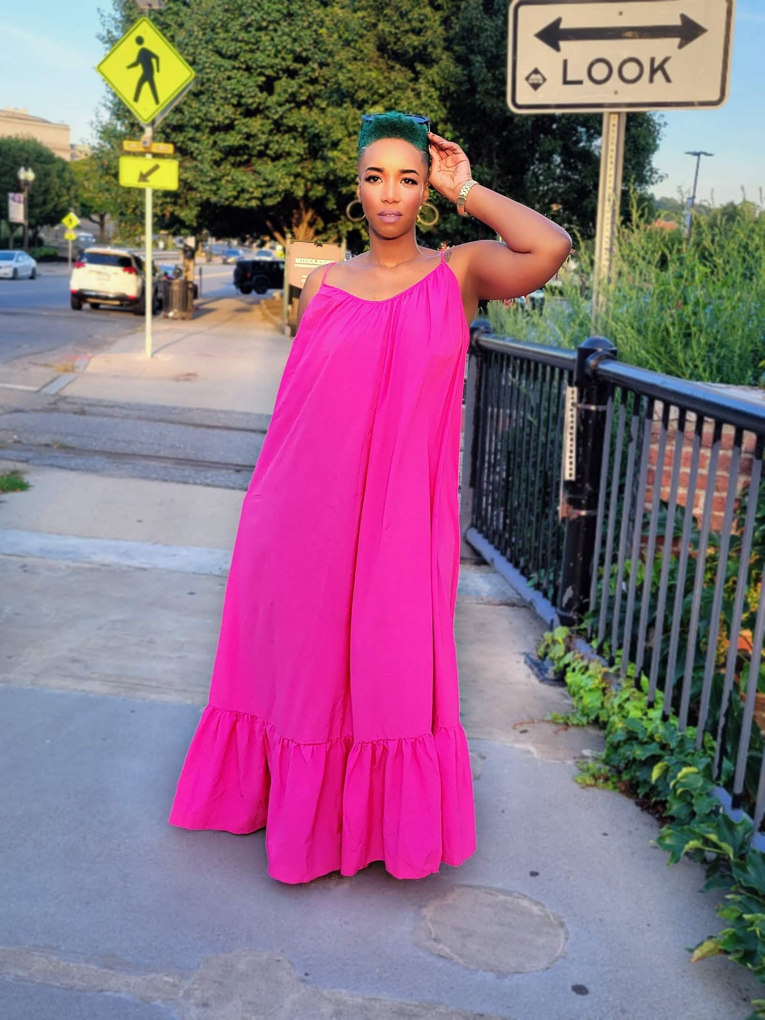 flamingo pink maxi-dress lovely ruched 3/4 floor touching dress. adjustable bra straps, model sports green mohawk hair with gold accessories' that completes the look
